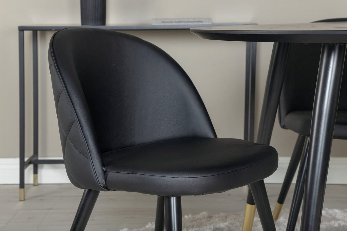 Rundes Dipp Esszimmerset: Esstisch ⌀115 cm mit schwarzem Furnier und schwarzen Beinen, dazu vier Velvet-Stühle mit schwarz-grauem Mikrofaserbezug.