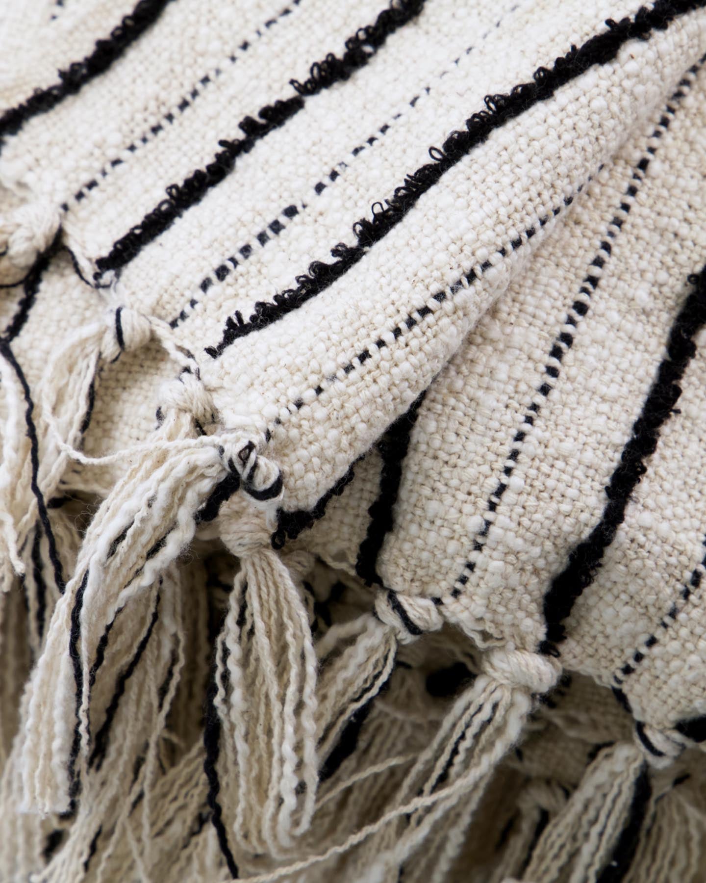Verleihen Sie Ihrem Zuhause mit der handgewebten HDLines Decke von House Doctor in Schwarz und Off-White einen Hauch von Eleganz und Gemütlichkeit.
