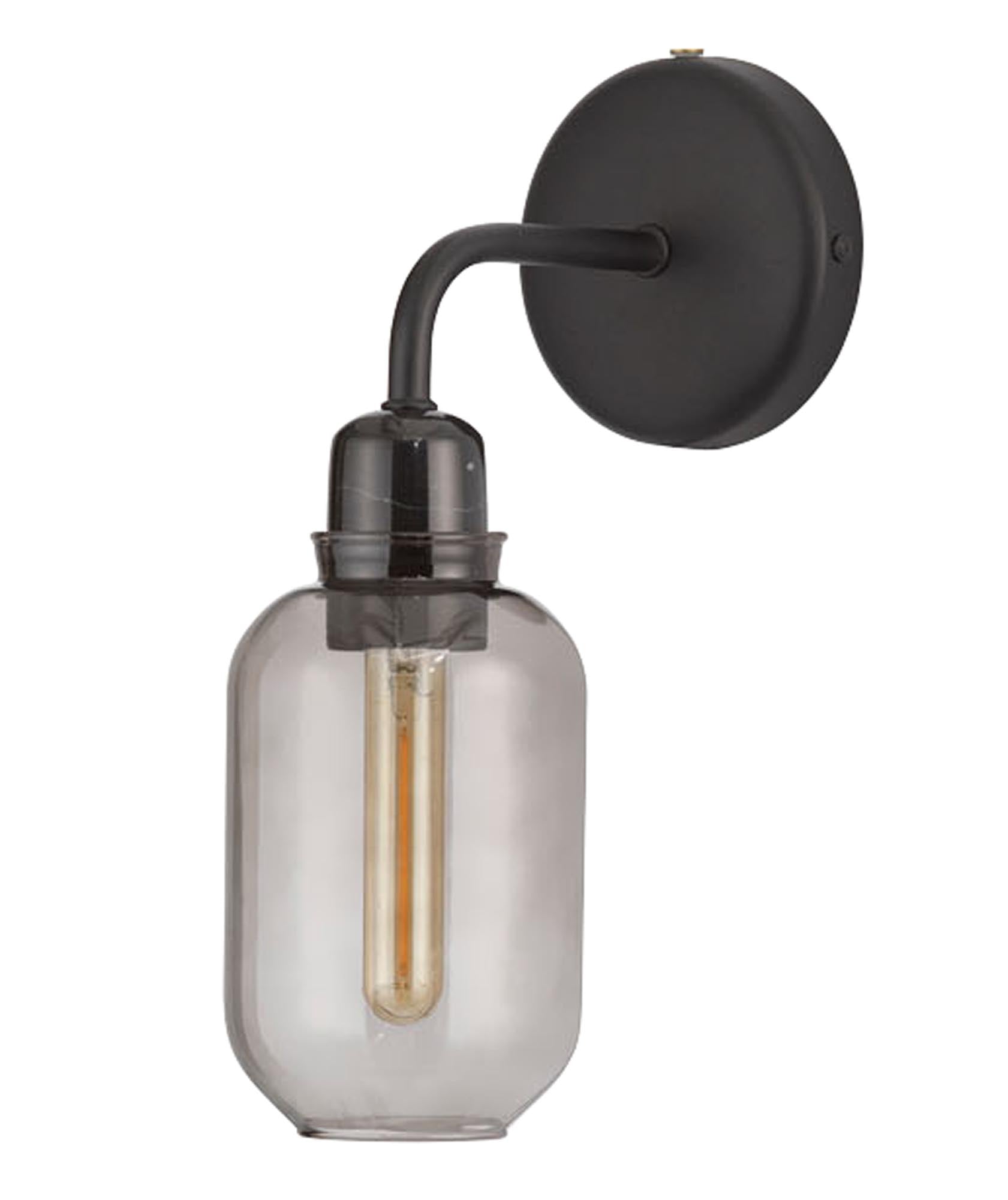 Die Amp Wandlampe von Normann Copenhagen in edlem Rauchschwarz kombiniert hochwertiges Glas und Marmor für ein modernes Ambiente.