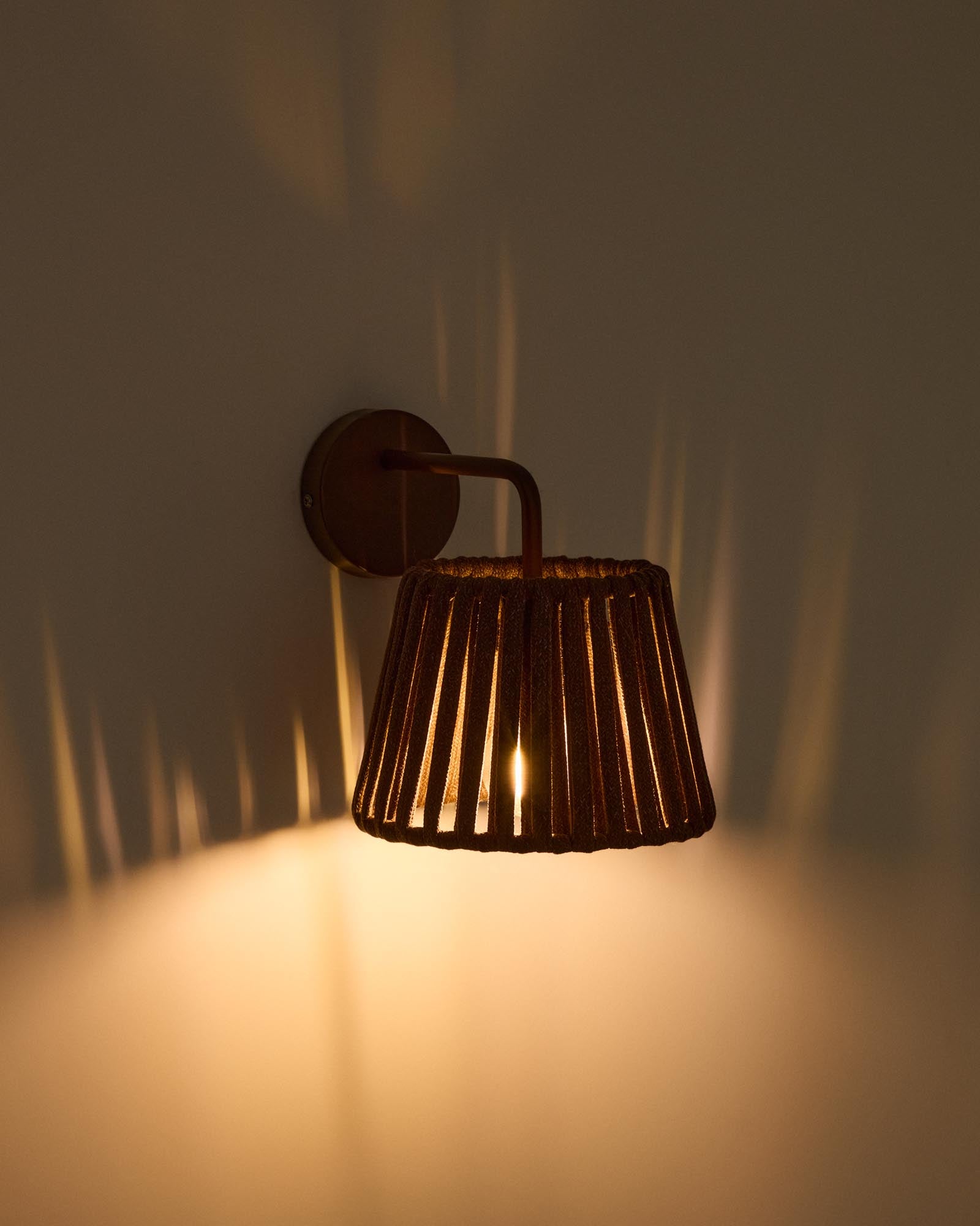 Stylische Outdoor-Wandleuchte Aldet aus robustem Seil und elegantem braunem Metall, ideal für stimmungsvolle Abende im Freien.