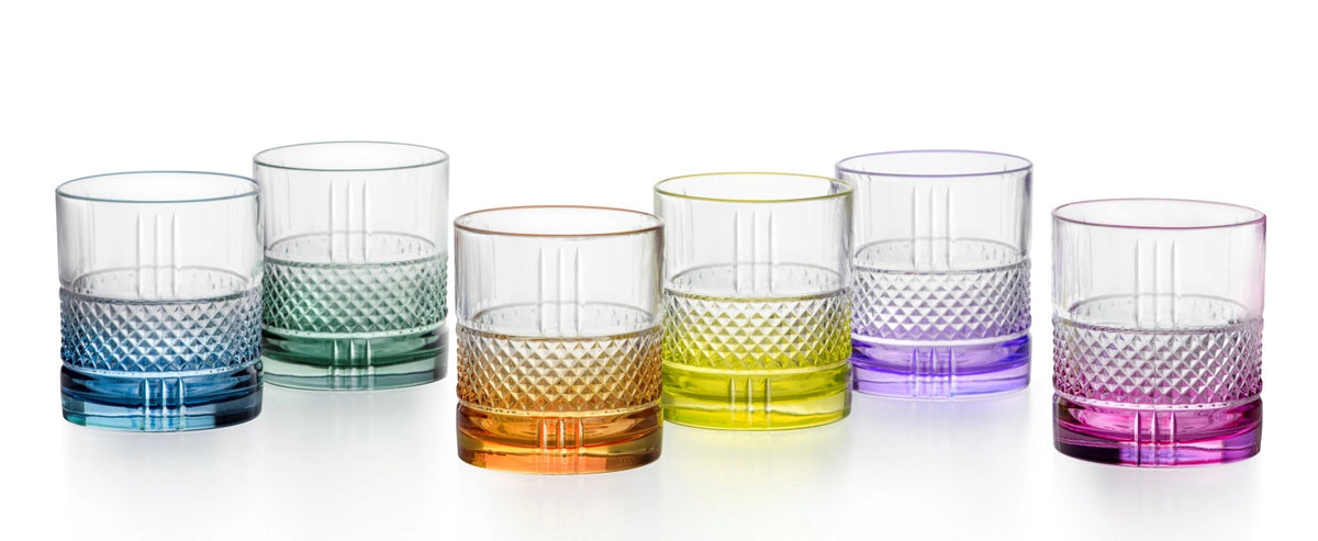 Sechs mehrfarbige Dof Trinkgläser aus Glas der RCR Brillante Color-Serie, je 34 cl, nebeneinander auf einer hellen Fläche aufgestellt.
