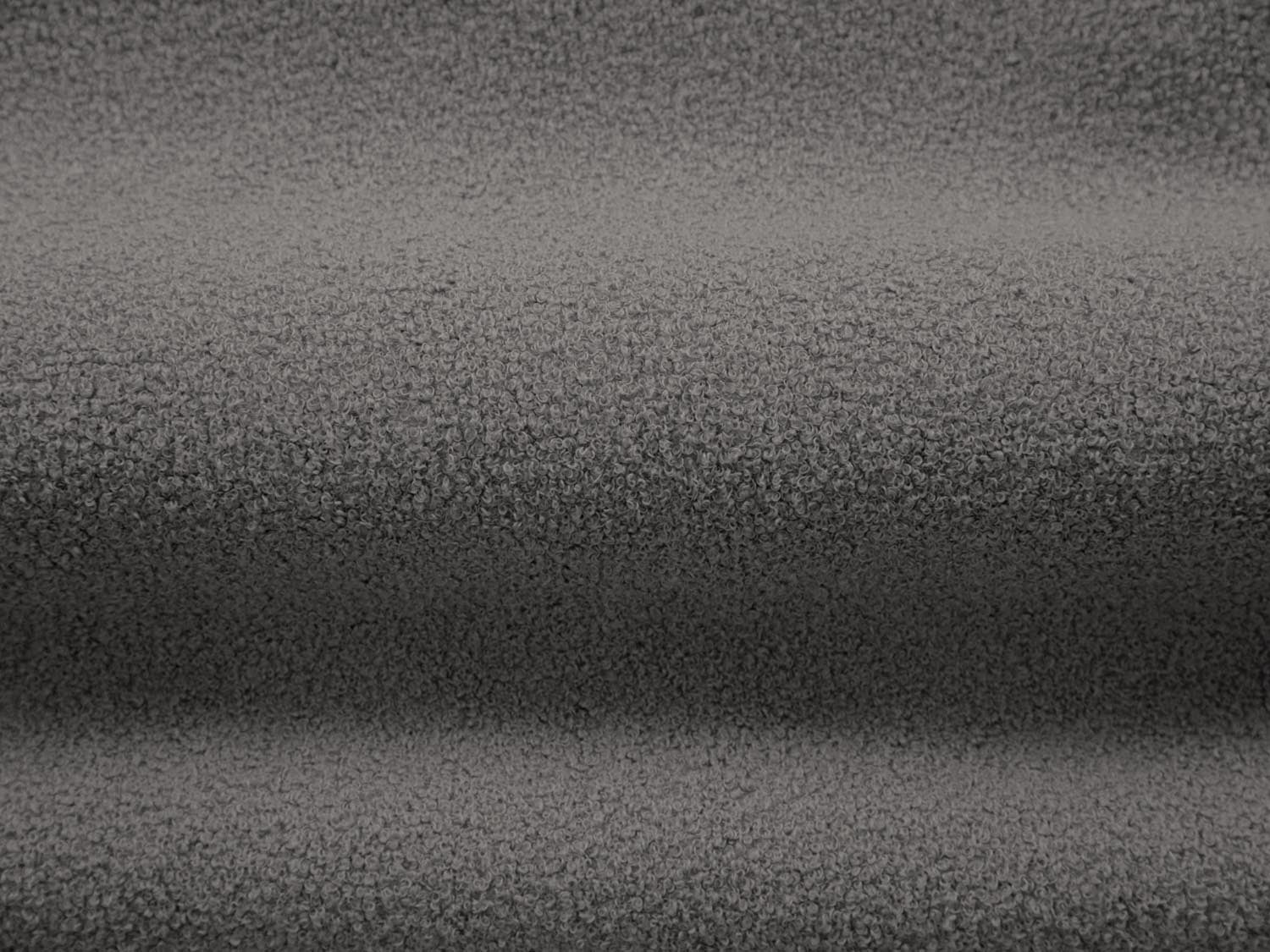 Stylischer Drehsessel Chuck Swivel Boucle in einem warmen Grauton, perfekt für entspannte Stunden und zeitgemäße Inneneinrichtungen.