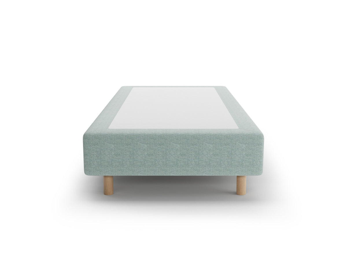 Bettgestell Whale von Micadoni in leichtem Beige mit Chenille-Bezug und Buchenholzbeinen, minimalistische Form ohne Kopfteil, Ansicht von schräg vorne.