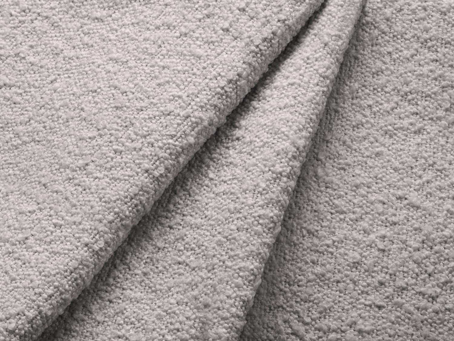 Stylisches Jodie Boucle Ecksofa in sanftem Grau, ideal für kleine Räume, mit praktischer Schlaffunktion und Stauraum für Kissen und Decken.