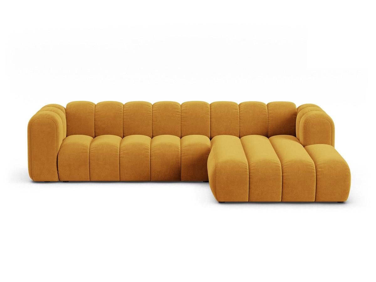 Linksseitig ausgerichtetes Ecksofa Lupine mit Samtbezug in leichtem Beige, schwarzen Kunststoffbeinen und tiefer Sitzfläche, Frontalansicht