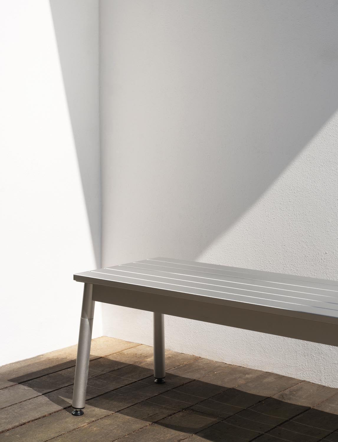Gartenbank Ex von Normann Copenhagen aus eloxiertem Aluminium mit schlanken, leicht versetzten Profilen und vier angewinkelten Beinen.