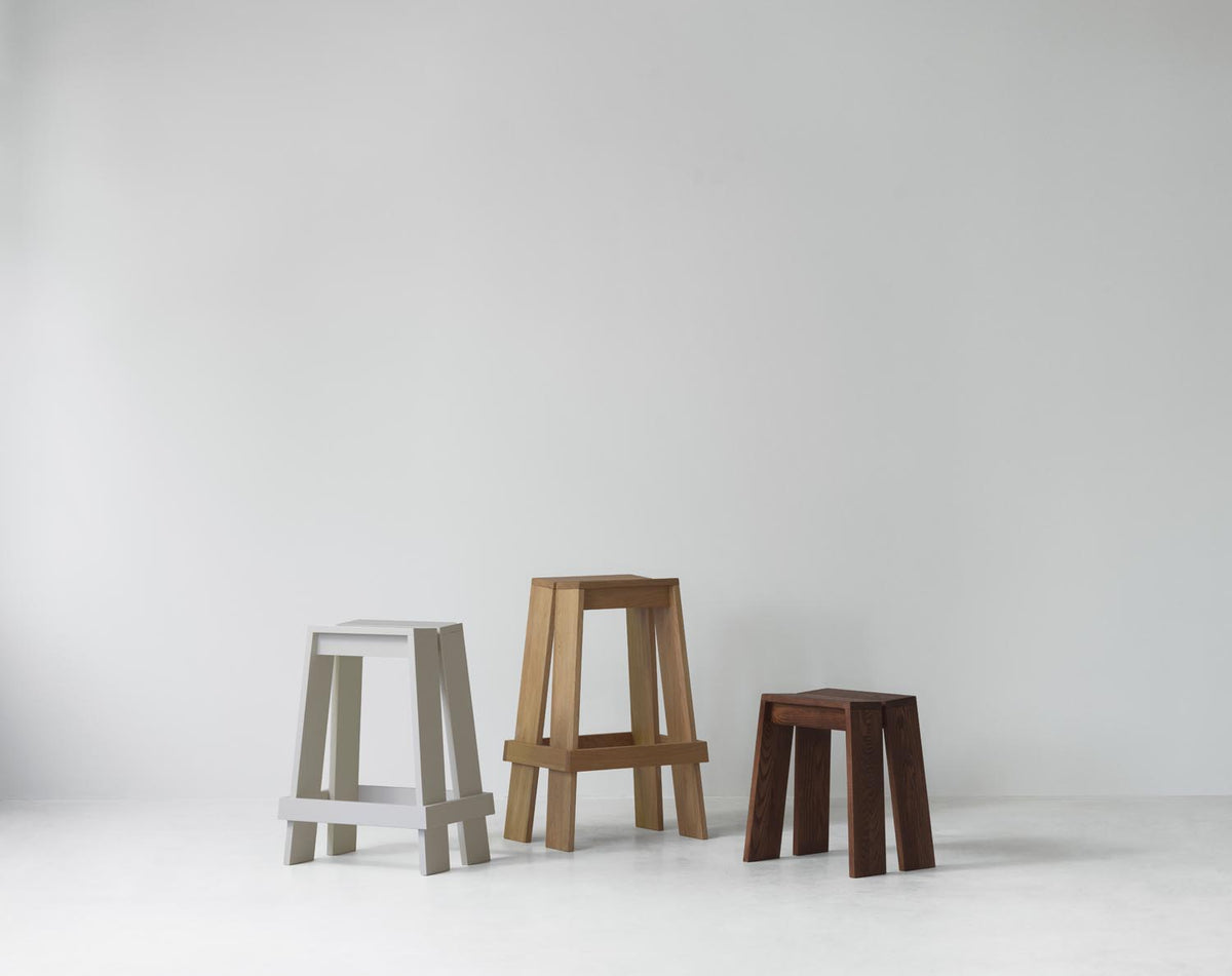 Hocker Let von Normann Copenhagen aus lackierter Eiche mit zwei parallelen, leicht geneigten Holzplanken als Sitzfläche und Beinen.