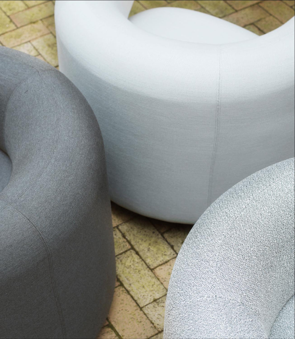 Drehsessel Burra Outdoor von Normann Copenhagen in Natté, Gestell aus Stahl und lackiertem Holz, runde skulpturale Sitzform.