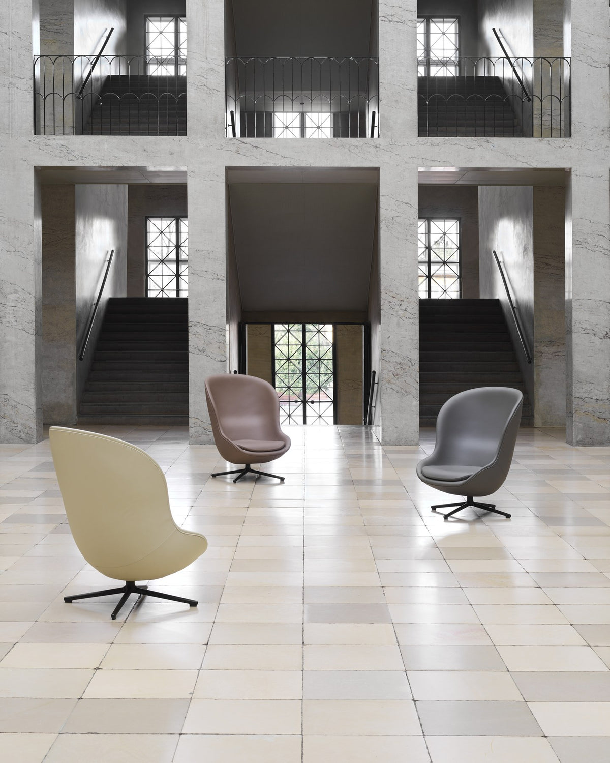 Gelber Hyg Lounge-Sessel von Normann Copenhagen mit hoher, konkaver Sitzschale aus PU-Schaum und Drehgestell aus schwarzem Aluminium.