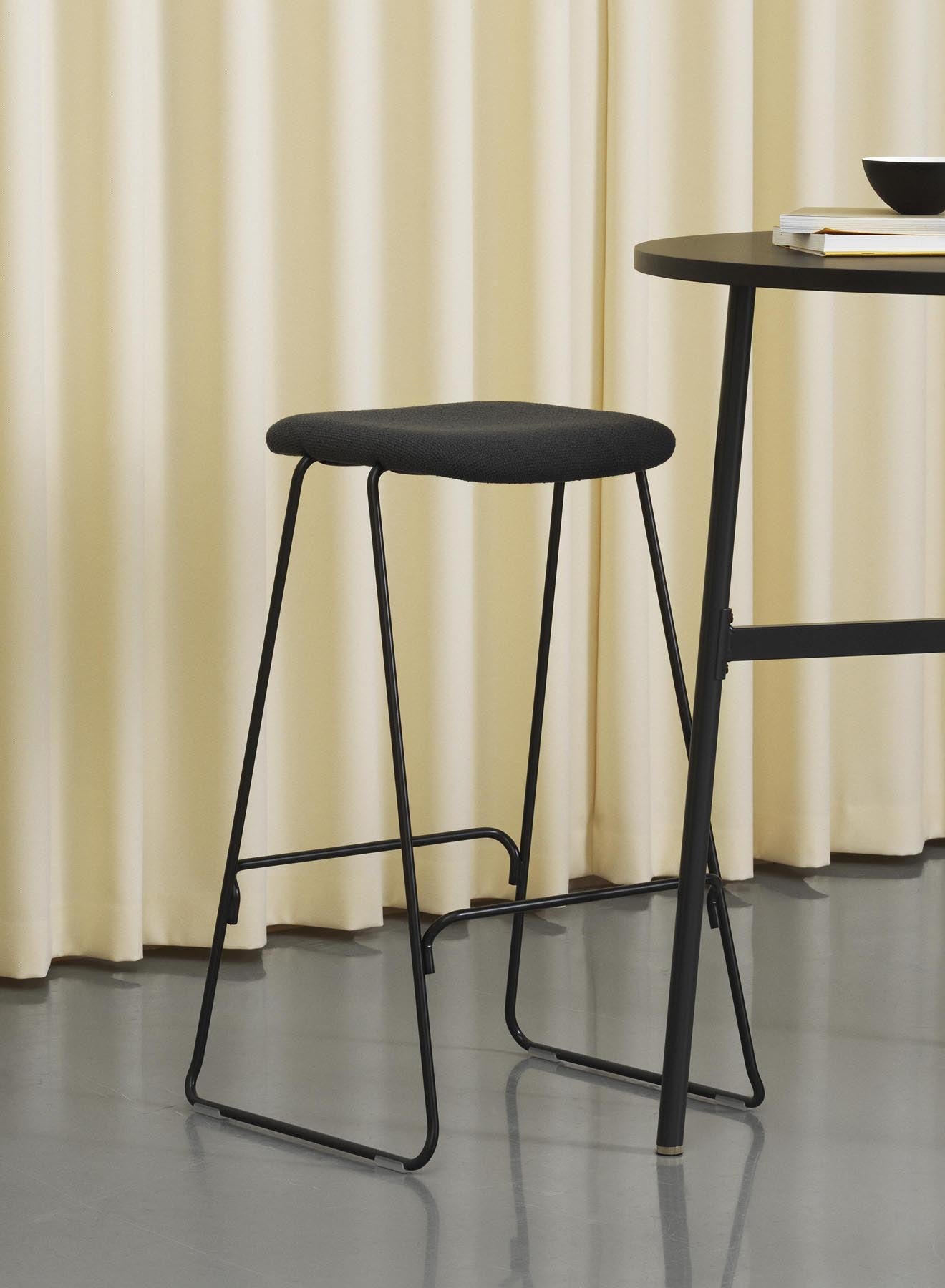 Erleben Sie den Just Barhocker 65 cm von Normann Copenhagen – ein stilvolles, gepolstertes Möbelstück aus robustem schwarzem Stahl und hochwertigem Remix-Stoff, perfekt für jede Einrichtung.