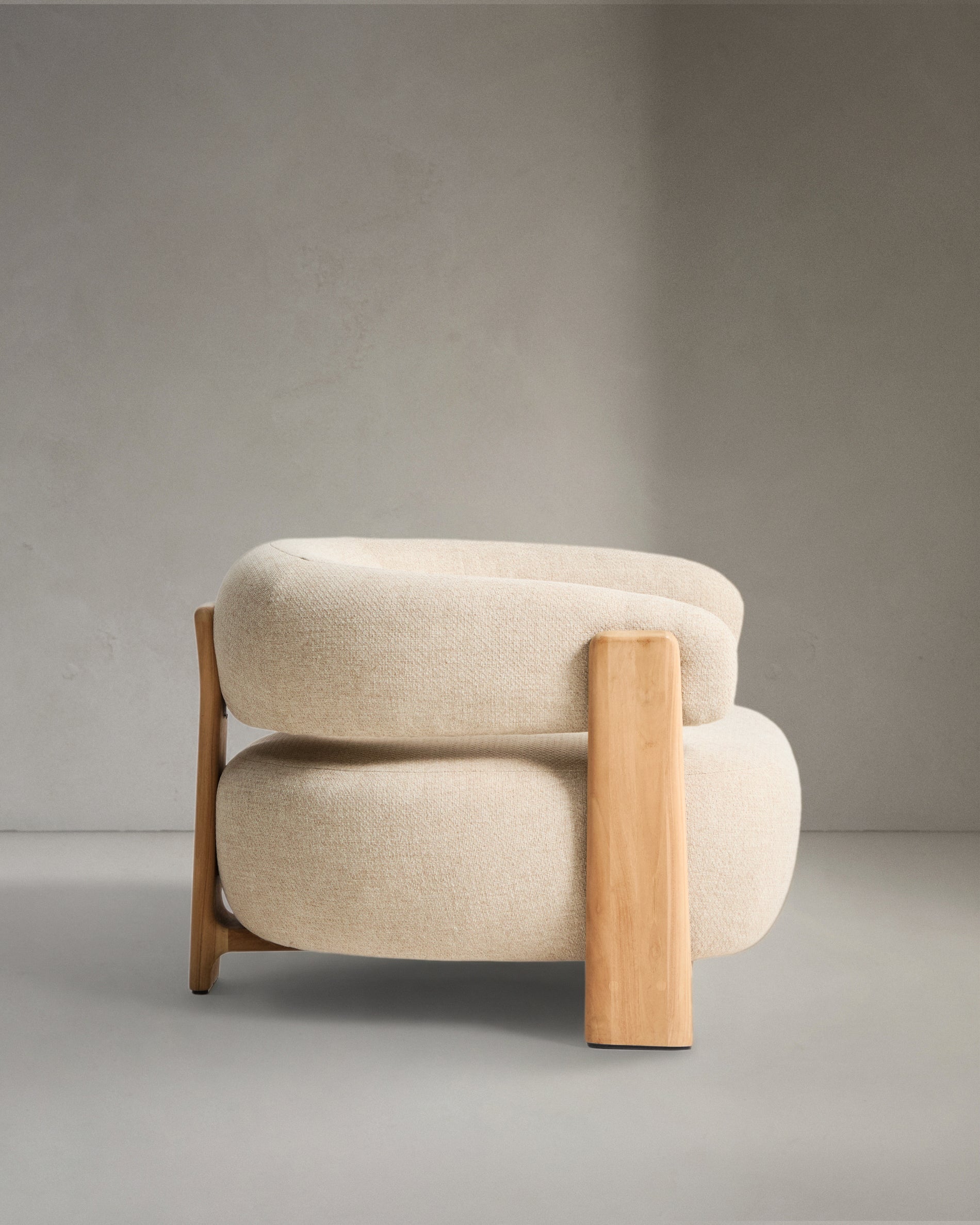 Eleganter beiger Outdoor-Sessel Granit mit stabilen Teakholzbeinen, perfekt für entspannte Stunden im Freien, von Kave Home.