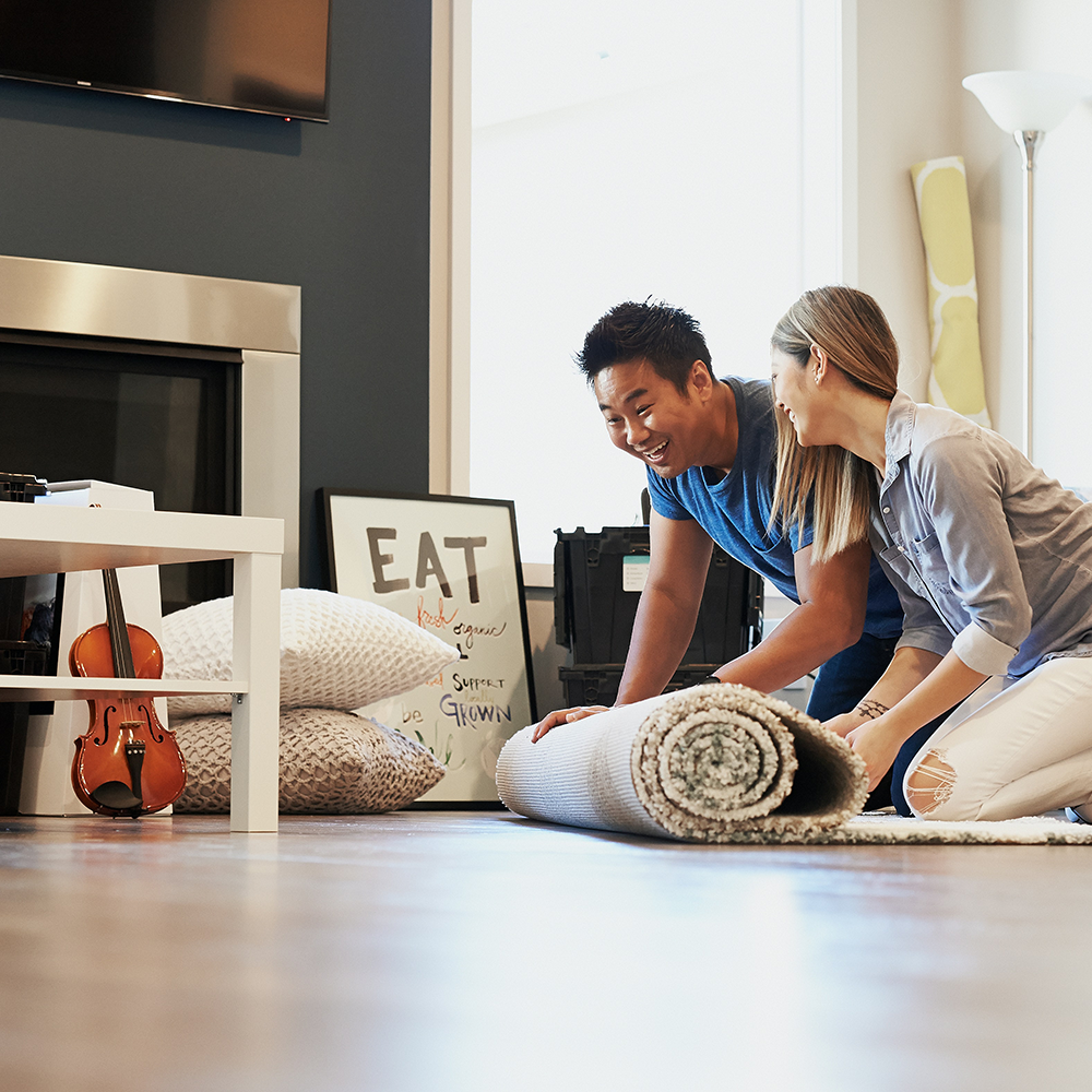 Glückliches Paar ist beschäftigt mit der Neueinrichtung ihrer Wohnung