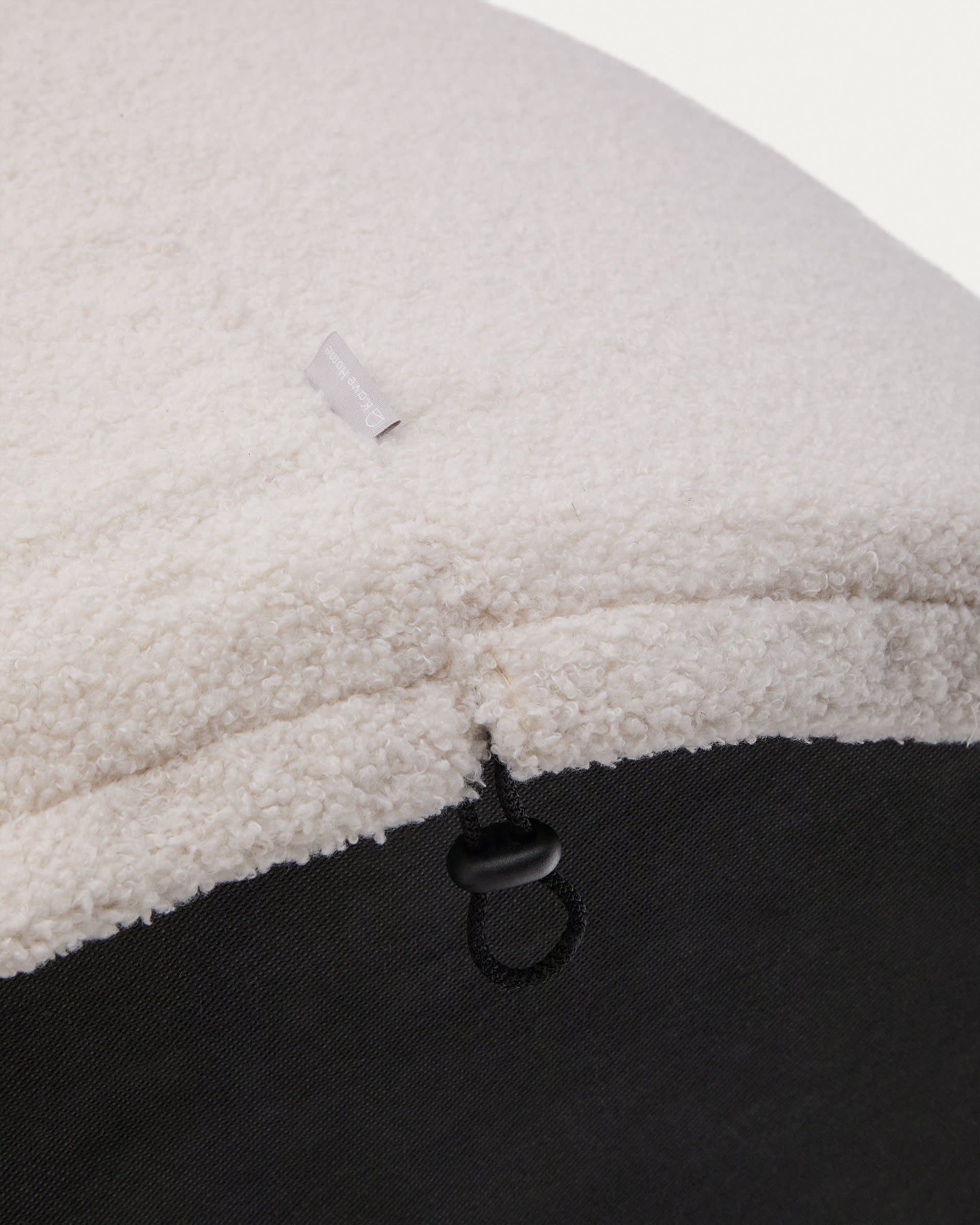 Stilvoller Fusshocker Kaeli in Écru Bouclé, Ø 60 cm. Abnehmbarer Bezug für mühelose Reinigung. Ideal für Komfort und Eleganz in jedem Raum.