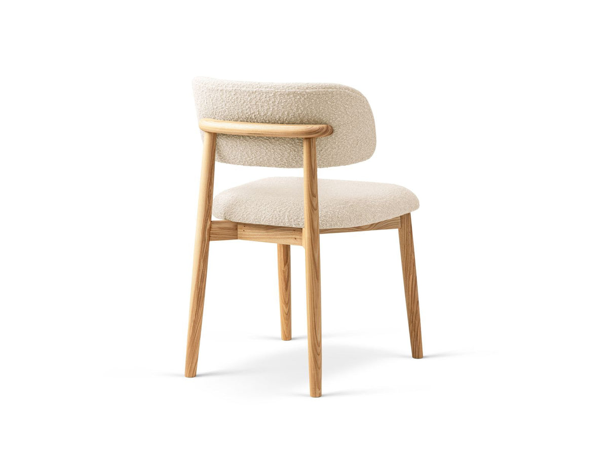 Zwei Boucle-Stühle Evan in Beige mit Buchenholz-Beinen, strukturiertem Bouclé-Bezug und gepolsterter Sitzfläche vor neutralem Hintergrund.