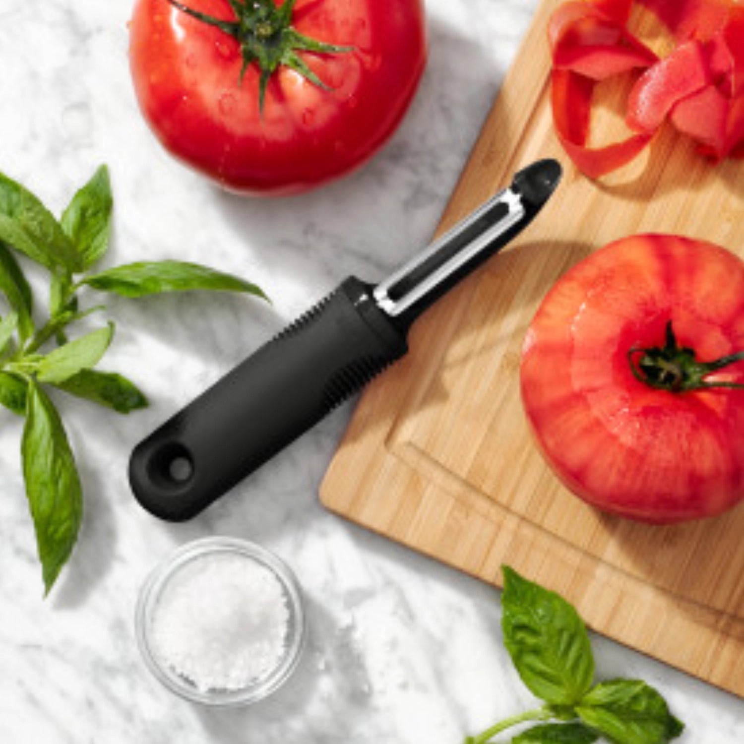 Praktischer gezackter Schäler von OXO, perfekt für müheloses Schälen von verschiedenen Obst- und Gemüsesorten, mit rutschfestem Griff für optimale Kontrolle.