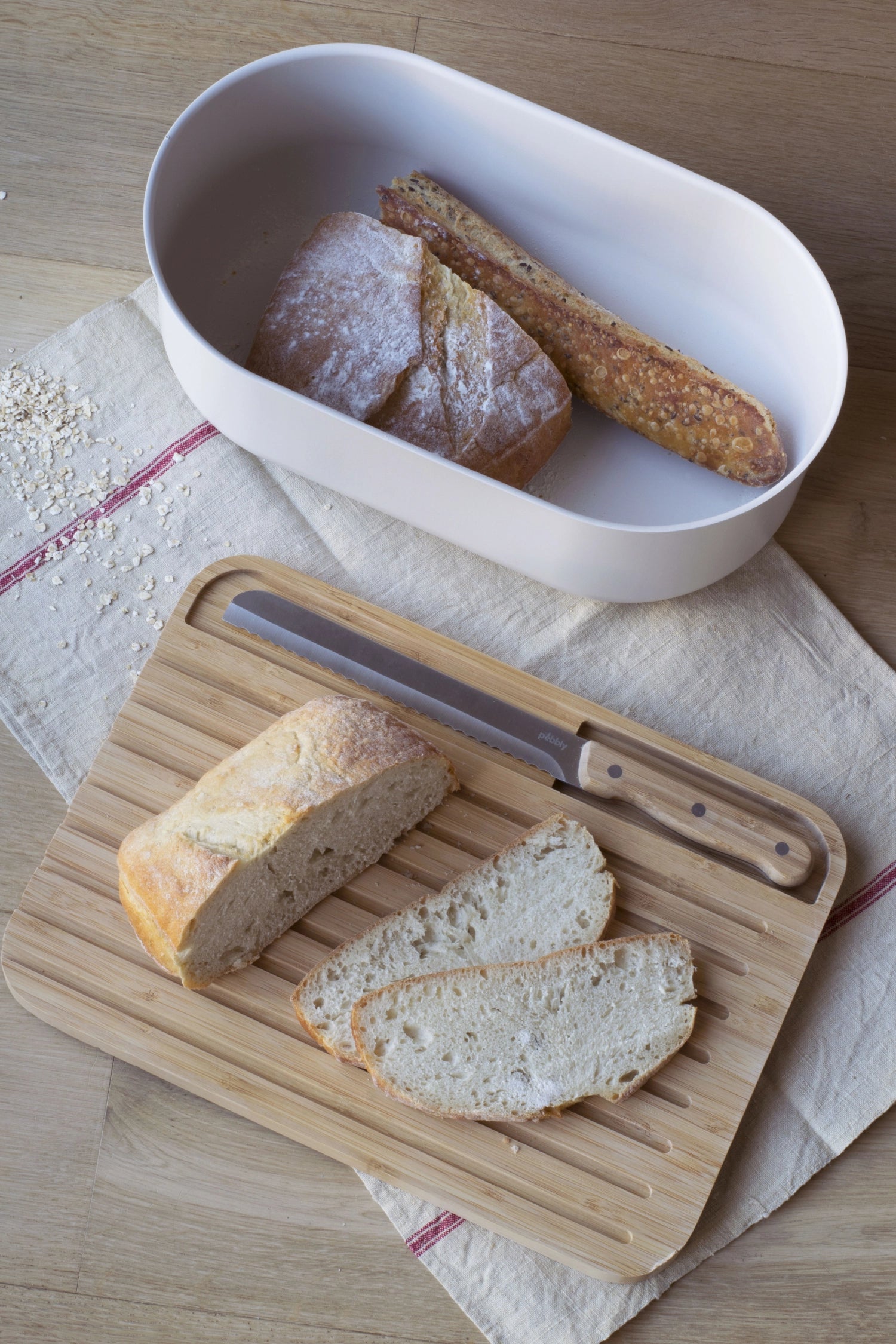 Stilvoller Brotkasten von Pebbly in Cream, inklusive Schneidebrett, Messer und Brotbeutel – perfekt für die Aufbewahrung von frischem Brot.