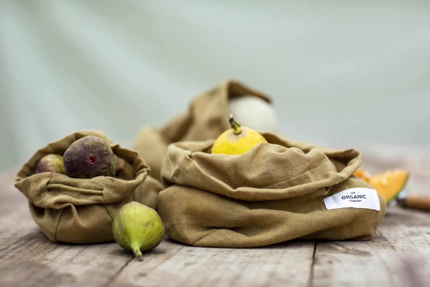 Set aus drei khaki Beuteln aus Biobaumwolle von The Organic Company, perfekt für nachhaltige Aufbewahrung und umweltbewussten Einkauf.