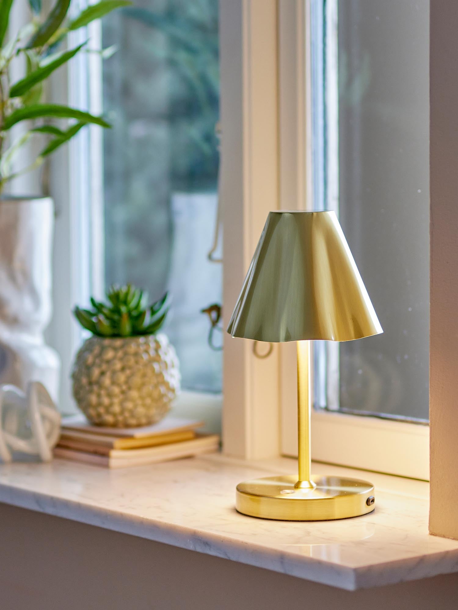 Die Lianna Lampe von Bloomingville ist eine tragbare, wiederaufladbare Tischlampe aus Messing, ideal für stilvolle Beleuchtung.