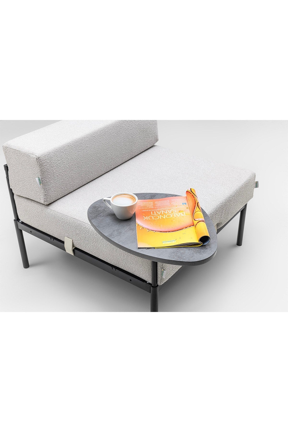 Foto eines 1-Sitzer-Sofamoduls in Schwarz/Grau mit Bouclé-Stoff, Metallgestell, Metallbeinen und integriertem Beistelltisch von Hanah Home.