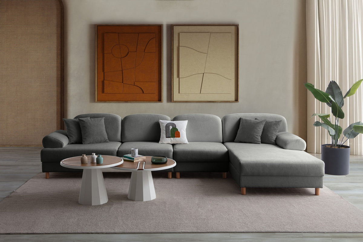 Anthrazitfarbenes Eck-Schlafsofa mit Coco-Boucle-Stoffbezug, Holzbeinen und rechter Truhe, fotografiert freistehend im Raum.