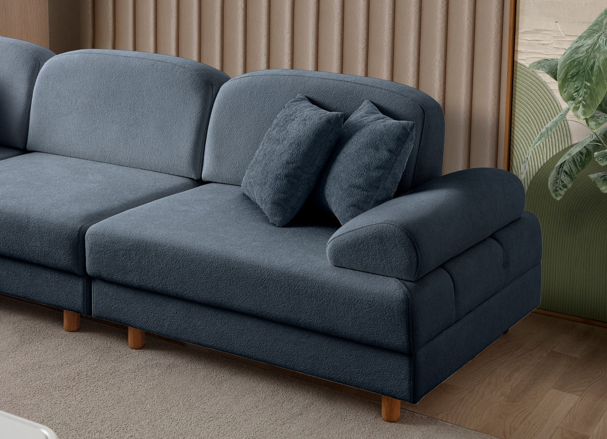 Marineblaues Eck-Schlafsofa Aries Modular M von Hanah Home mit Coco-Boucle-Stoffbezug, Holzbeinen und ausklappbarer Liegefläche.