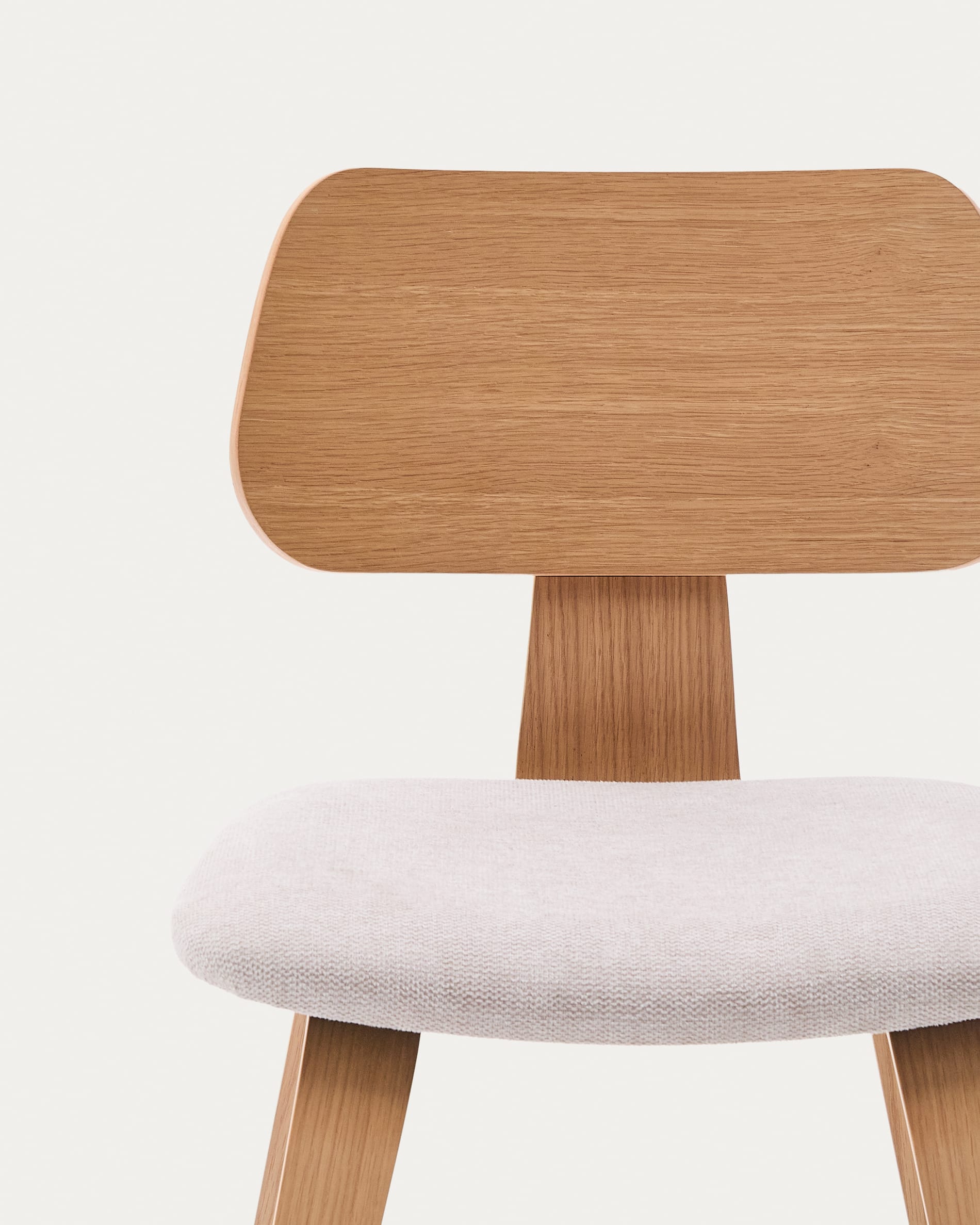 Der Stuhl Gena kombiniert eine beige Chenille-Sitzfläche mit einem Eichenfurnier und einem Kautschukholzrahmen für modernen Komfort.