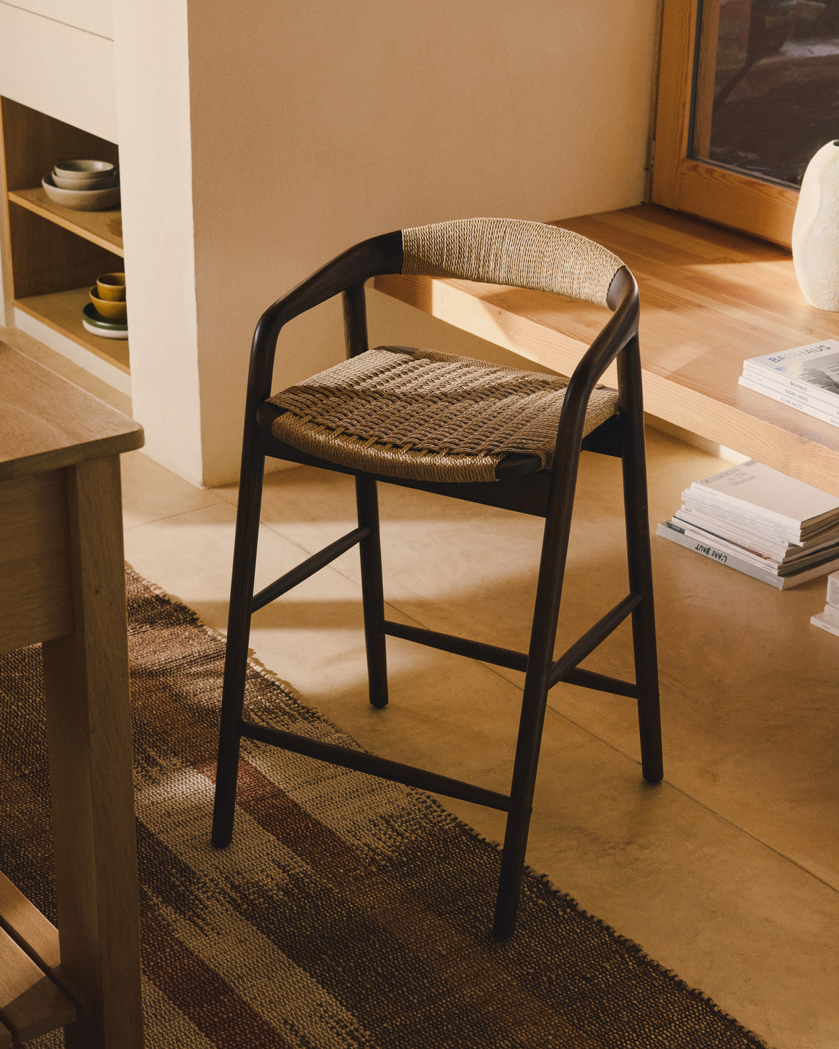 Hocker Derile aus massivem Eichenholz mit Nussbaum-Finish und beigem Papierseil FSC Mix Credit 65 cm in Beige präsentiert im Onlineshop von KAQTU Design AG. Barstuhl mit Armlehne ist von Kave Home