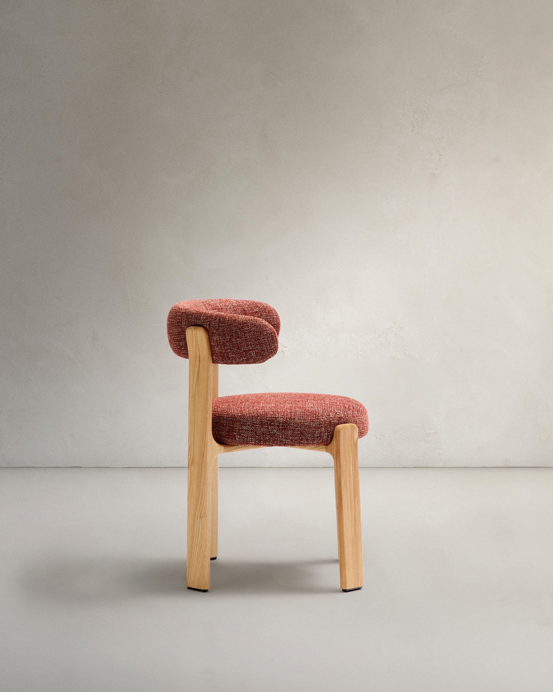 Moderner Stuhl mit terrakottafarbener Chenille, robustem Eschenholzrahmen in natürlichem Finish, nachhaltig und FSC-zertifiziert.