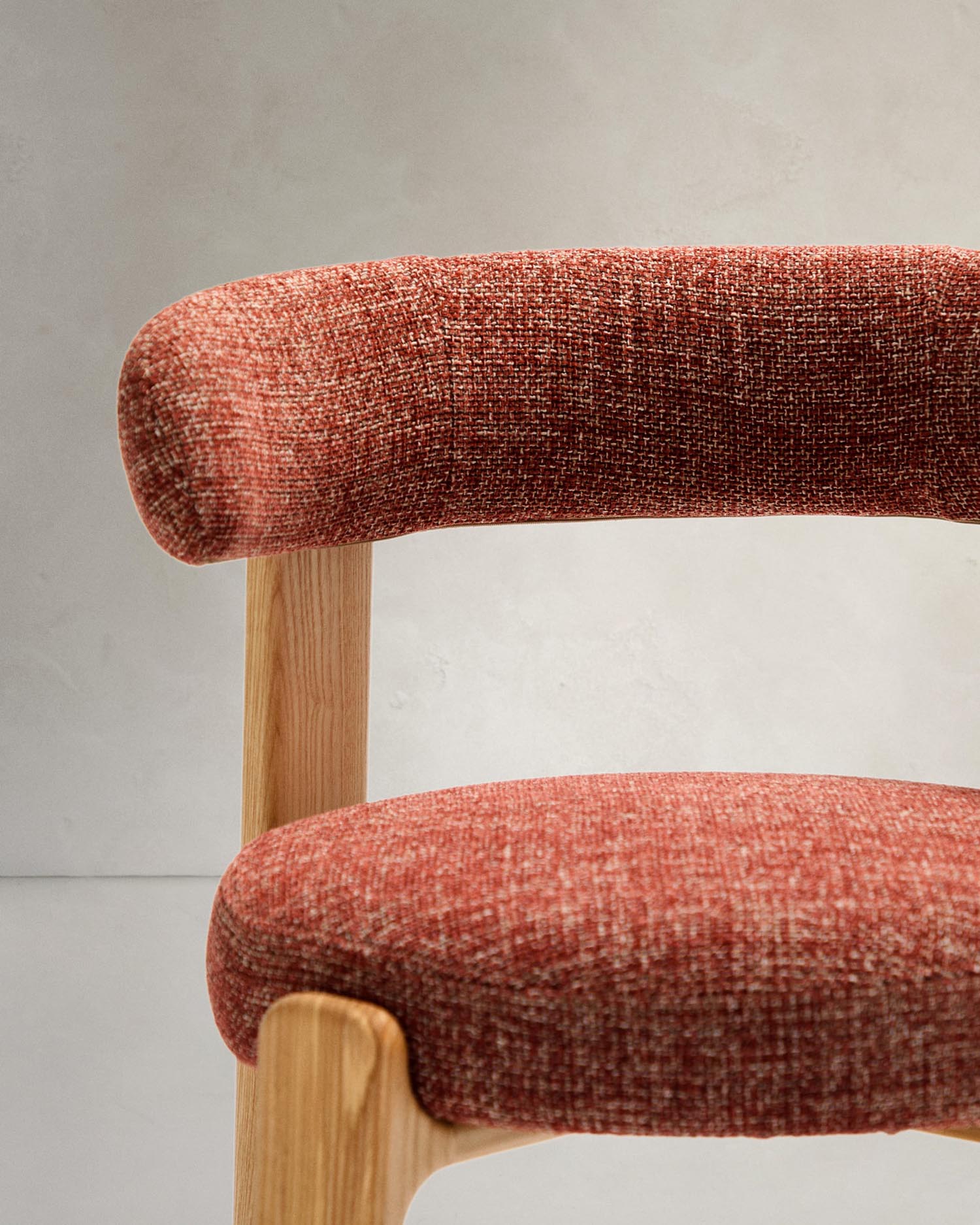 Moderner Stuhl mit terrakottafarbener Chenille, robustem Eschenholzrahmen im natürlichen Finish, nachhaltig und FSC-zertifiziert.