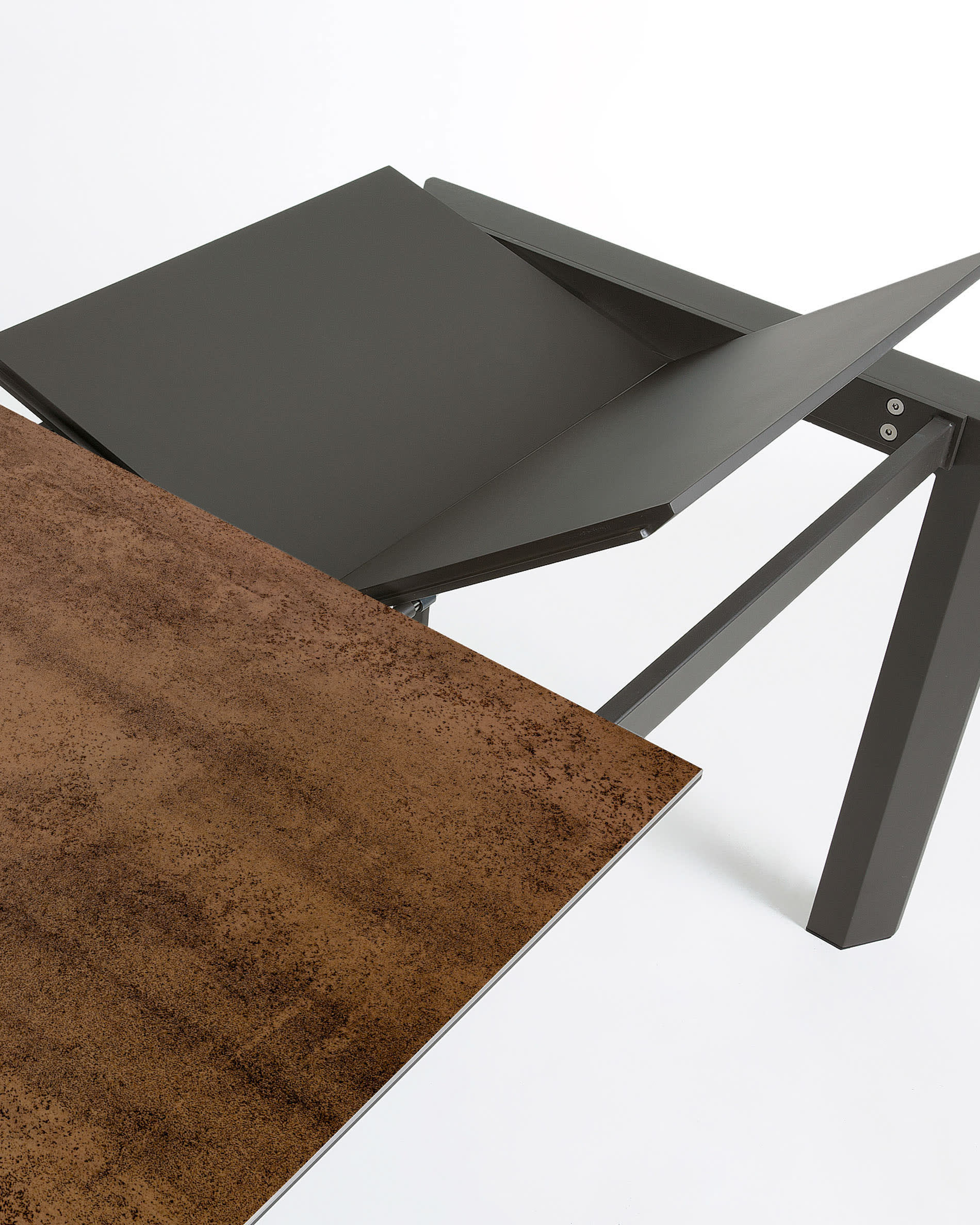 Eleganter Ausziehtisch mit Feinsteinzeugplatte in Iron Corten Optik und dunkelgrauen Beinen, ausziehbar von 120 auf 180 cm.