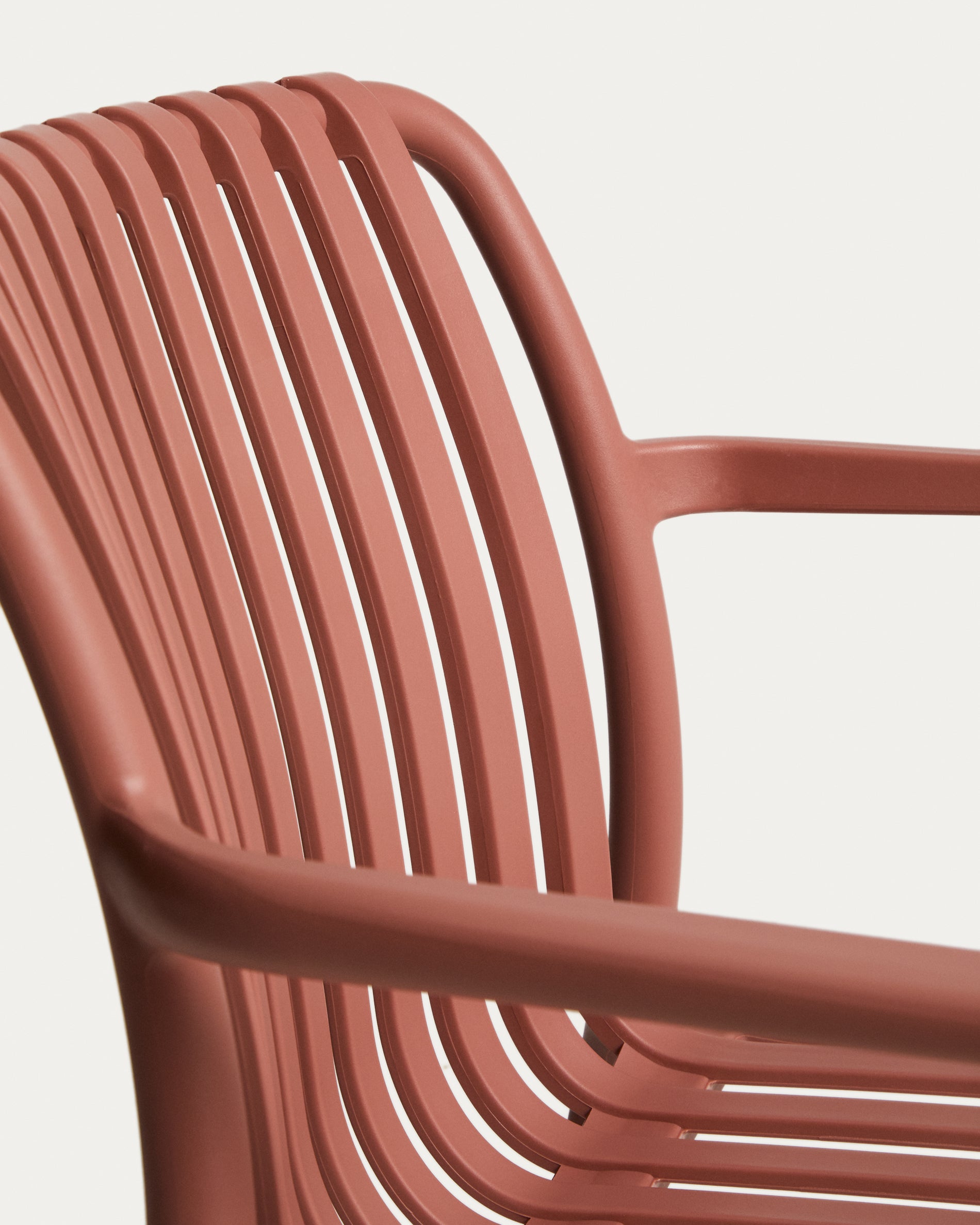Eleganter stapelbarer Gartenstuhl Isabellini in warmem Terrakotta, ideal für gemütliche Stunden im Freien und moderne Terrassengestaltung.
