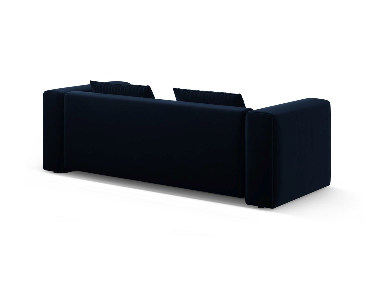 Sandfarbenes Samt-Bettsofa Verona mit drei Sitzplätzen, ausklappbarer Liegefläche, Bettkasten und schwarzen Kunststoffbeinen im Wohnraum.