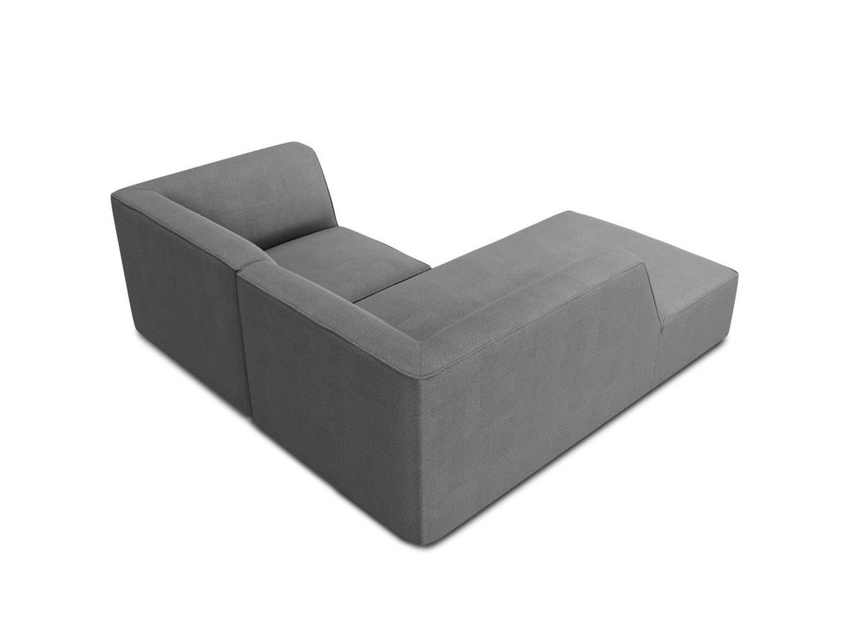 Modulares Ecksofa Siena mit gelbem Ottawa-Stoffbezug, schwarzen Kunststoffbeinen und Récamiere, Ansicht von vorne im Wohnraum.