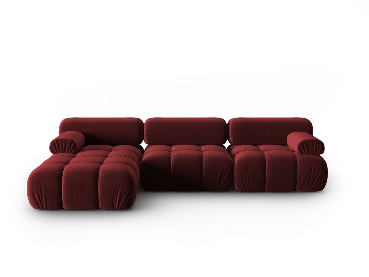 Modulares Ecksofa mit rosa Samtstoff, schwarzen Kunststoffbeinen und gepolsterter Récamiere, Ansicht von vorne links.