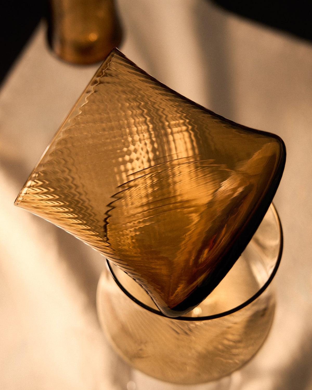 Weinglas Alori aus hellorangem Bernsteinglas mit dezentem Relief, 34 cl Fassungsvermögen, Kave Home, auf weissem Hintergrund.