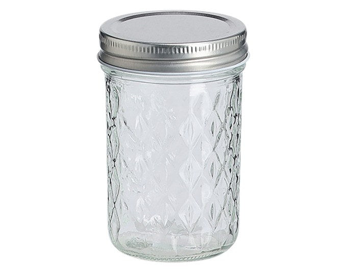Transparentes Vorratsglas mit strukturierter Glasoberfläche und grauem Metalldeckel, zylindrische Form, Fassungsvermögen 250 ml.