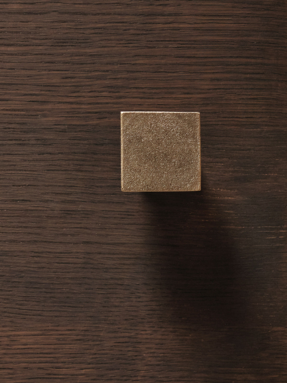 Kleiderhaken Square von Ferm Living aus massiv gegossenem Messing, geometrische Form aus Würfel und Zylinder, Farbton Casted Brass, Nahaufnahme.