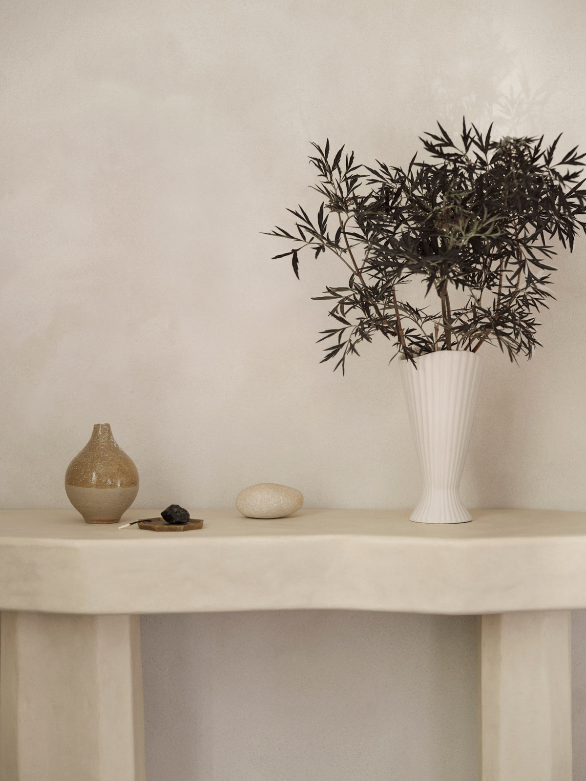 Fountain Vase von Ferm Living aus Steingut in Off-White, aussen matt und unglasiert, innen glasiert, mit gefältelter, geschwungener Form.