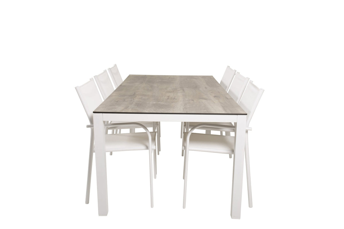 Zwei weisse Aluminium-Stühle mit Pulverbeschichtung und ein rechteckiger Esstisch mit grauer HPL-Tischplatte der Serie Santorini & Llama.