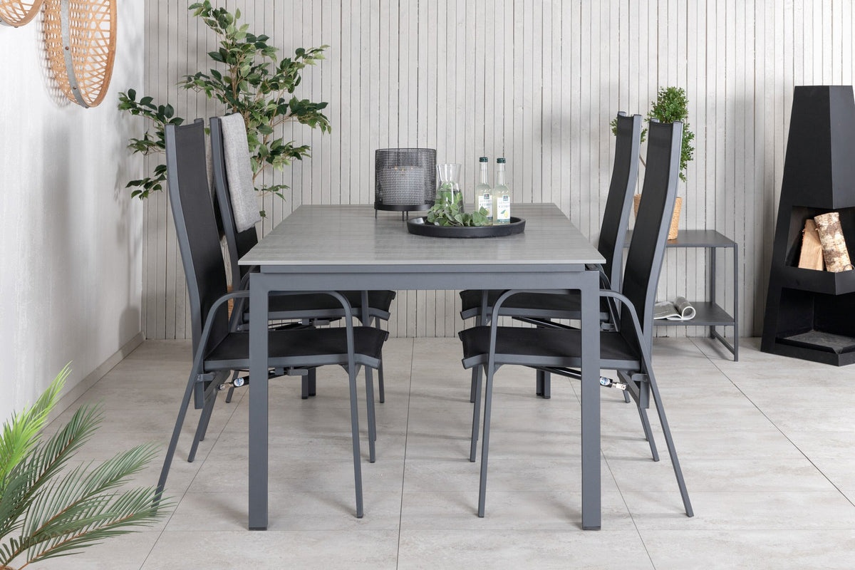 Schwarzer ausziehbarer Gartentisch Levels mit grauer Aintwood-Tischplatte und zwei stapelbaren Copacabana Sesseln aus Aluminium und Aintwood.
