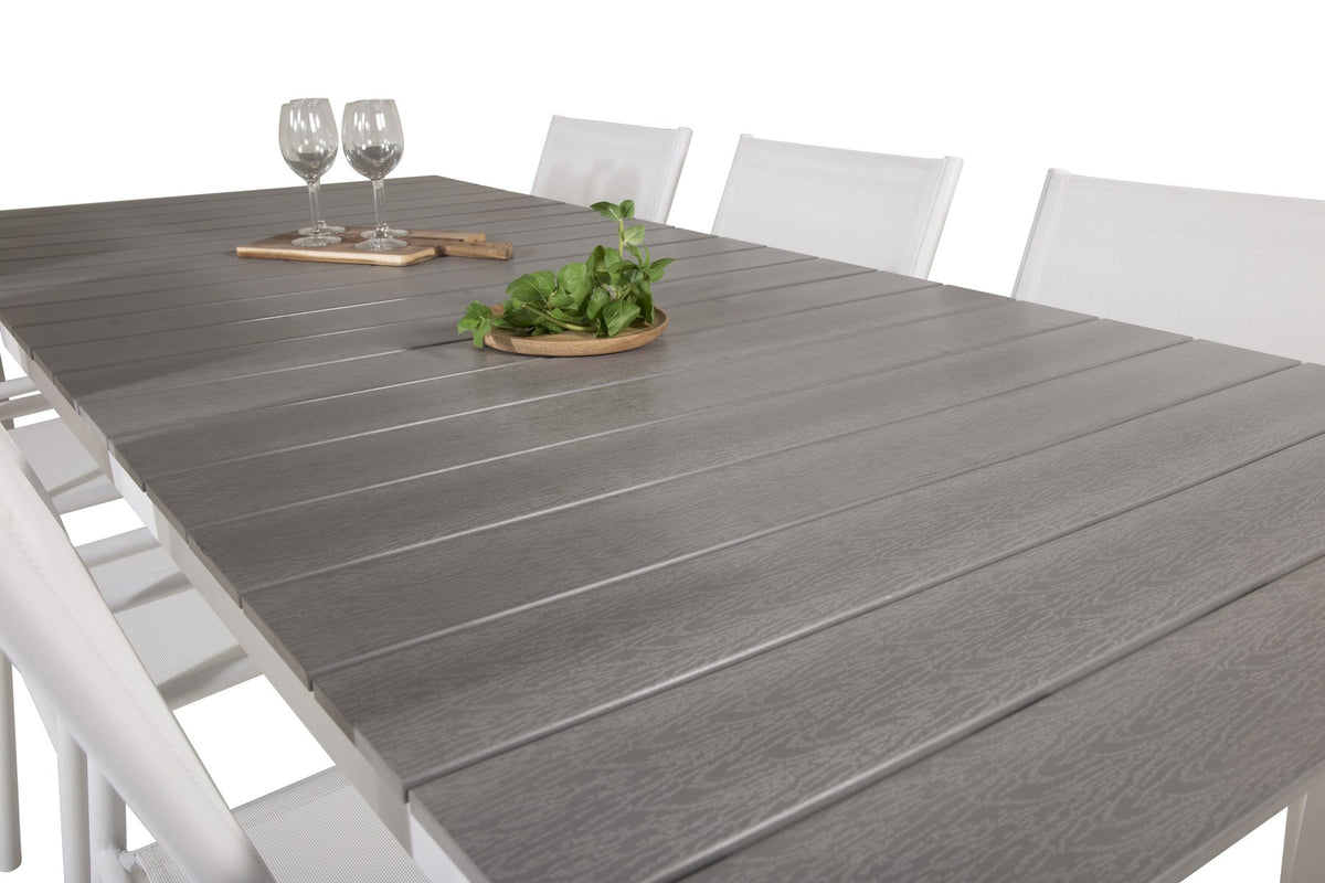 Weisses Gartentischset Levels & Santorini von Venture Home: rechteckiger Esstisch aus Aluminium und Aintwood mit stapelbaren Stühlen in Weiss.