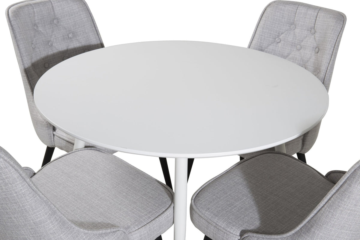 Runder Esstisch aus MDF mit weisser Tischplatte und Stahlbeinen, dazu zwei graue Esszimmerstühle mit Samtbezug und schwarzem Stahlgestell.