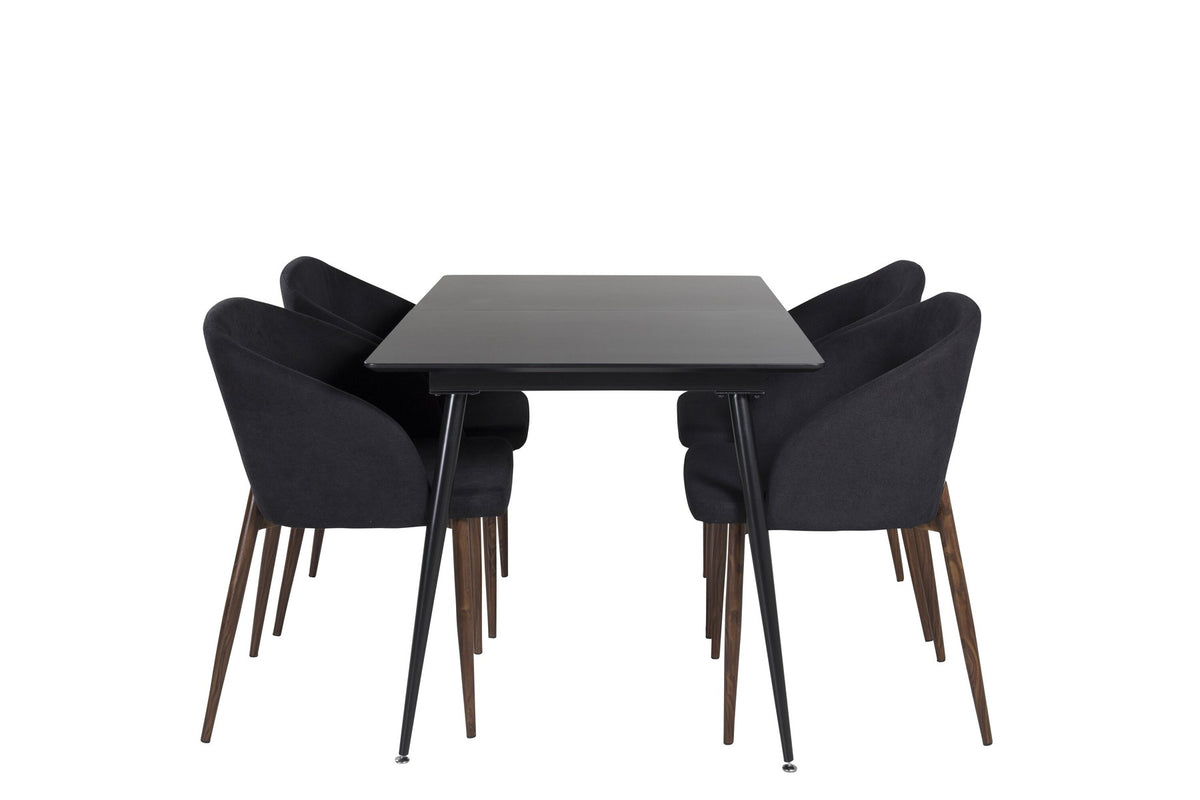 Rechteckiger Esstisch aus MDF und Stahl in Schwarz mit ausziehbarer Platte, daneben zwei Stühle mit Walnussbeinen und schwarzem Stoffbezug.