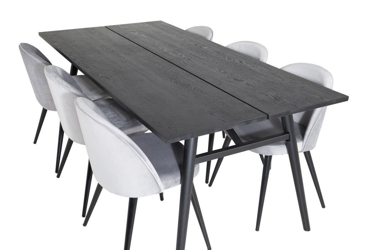 Rechteckiger Esstisch mit schwarzer Eichenplatte und Stahlbeinen, dazu zwei graue Stühle mit Stahlgestell aus dem Sleek & Velvet Set.