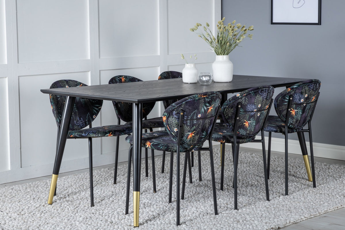 Schwarzes Esszimmerset Dipp mit Vault Stühlen: Tisch mit MDF-Furnierplatte und Stahlbeinen, Stühle mit Polsterbezug und Stahlgestell.