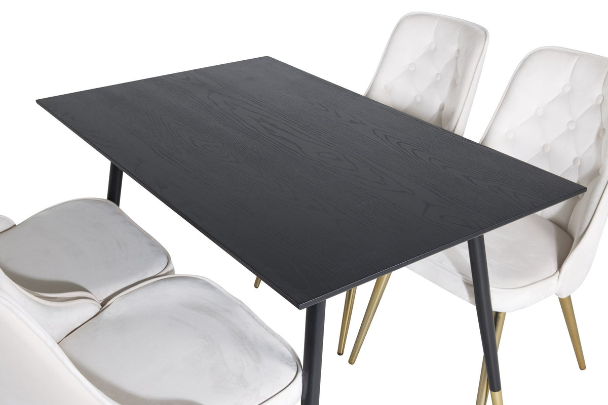 Rechteckiger Esstisch mit schwarzer MDF-Tischplatte und Stahlbeinen, daneben zwei gepolsterte Stühle in Beige mit Messing-Gestell.