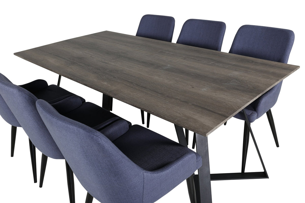 Zwei blaue Esszimmerstühle mit Stahlgestell und schwarz pulverbeschichteter Oberfläche neben einem rechteckigen MDF-Esstisch mit Stahlbeinen.