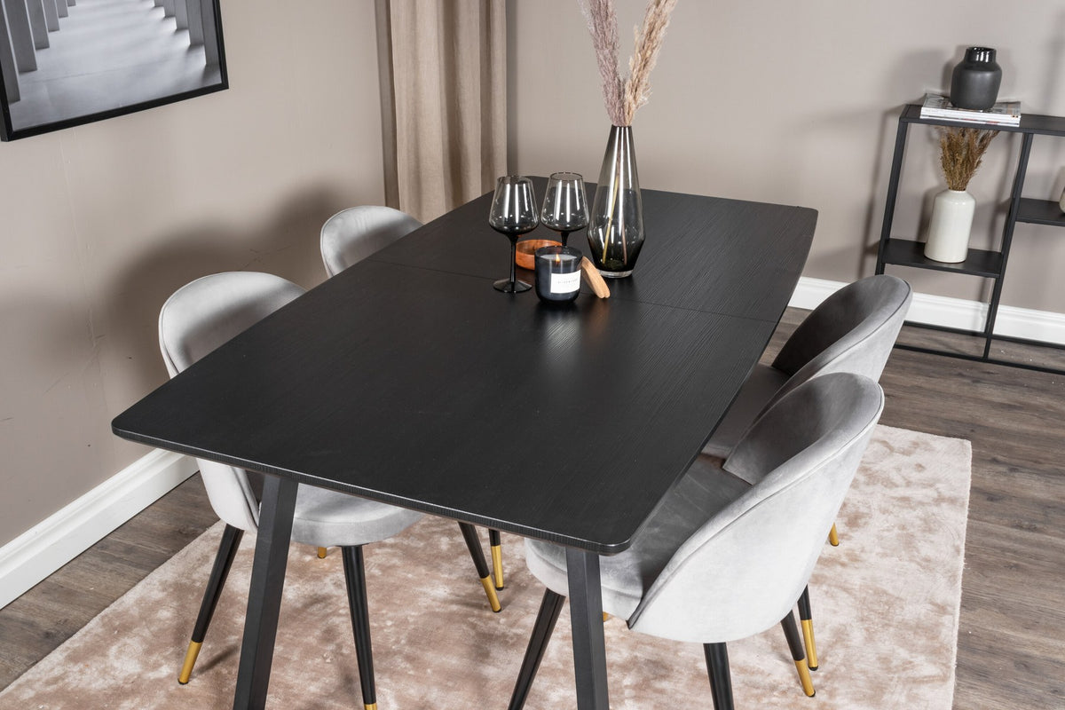 Esszimmerset Inca mit ausziehbarem Holztisch, schwarzer Tischplatte aus MDF und grauen Samtstühlen mit schwarzen Stahlbeinen der Serie Velvet.