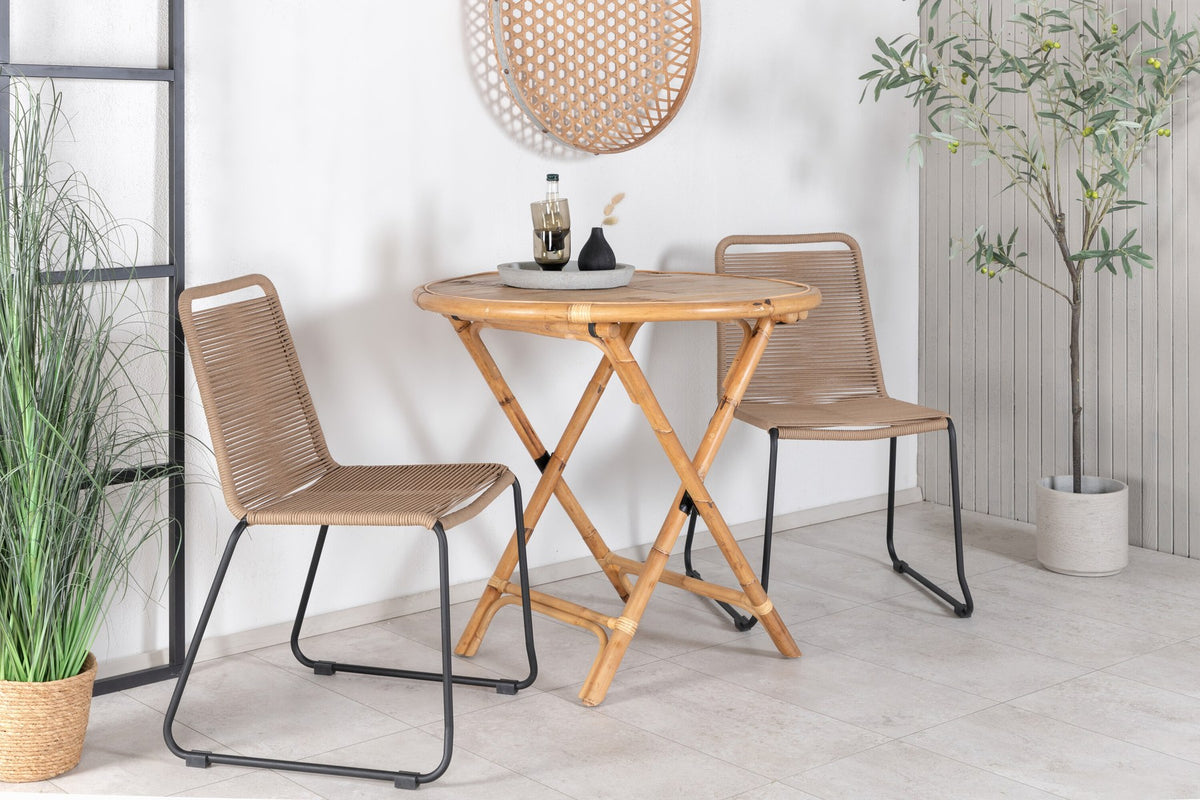 Runder Cafétisch aus Bambus mit Stahlbeinen in Natur, daneben zwei stapelbare Stühle aus Bambus und Rattan in Braun, Gartentischset.