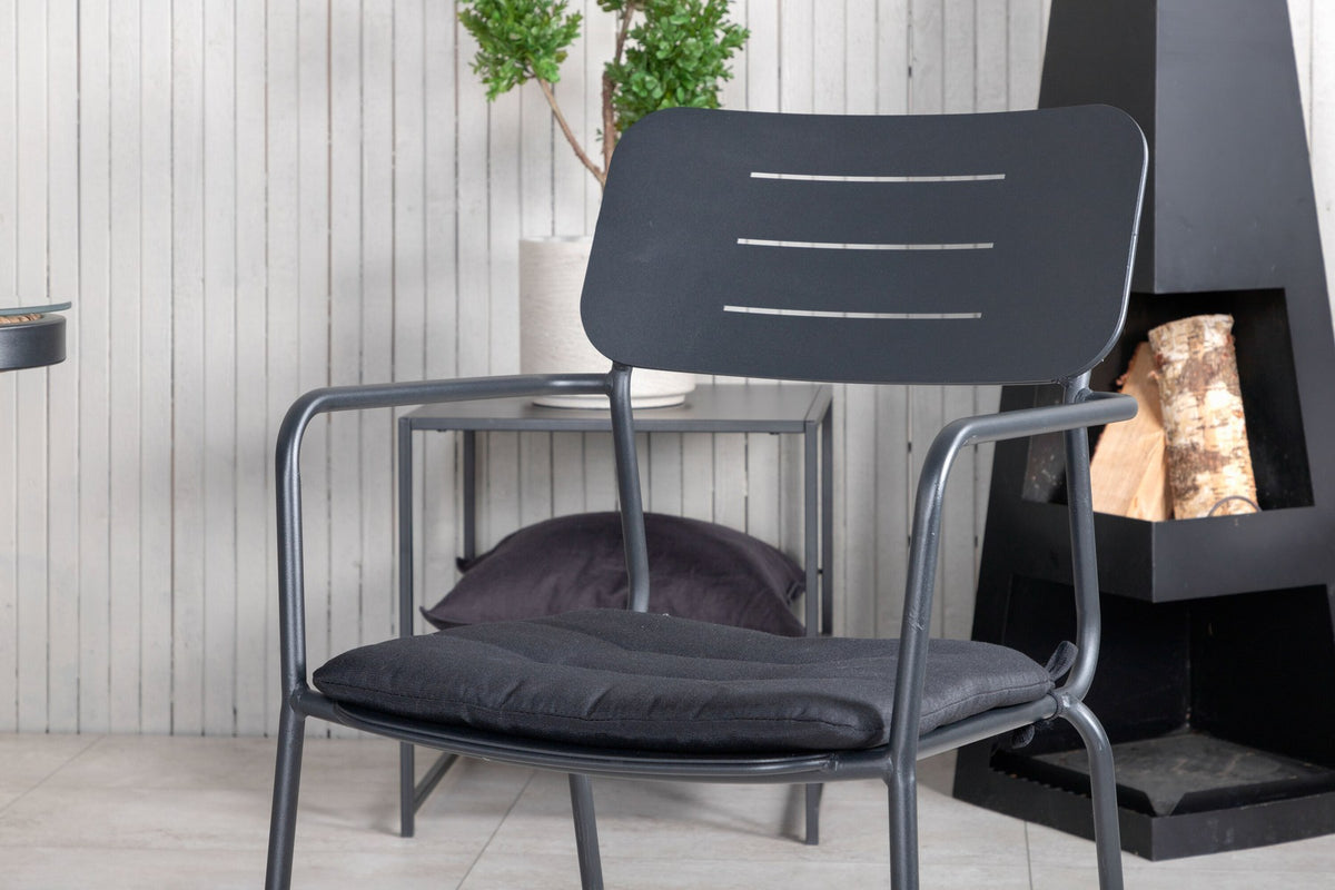 Zwei schwarze Esszimmerstühle mit Weidegeflecht und Polyesterseil sowie rechteckiger Glastisch mit Stahlbeinen, Masse 200x100 cm.